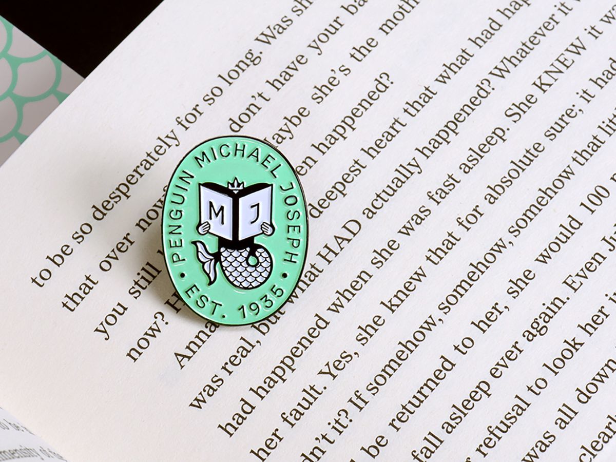 A badge sitting on a printed book.