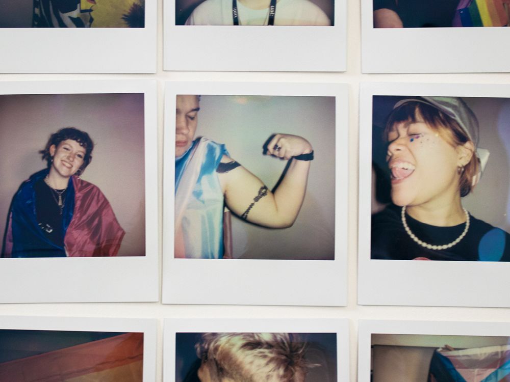 Rows of polaroids with people showing off Pride-themed props