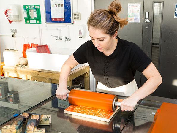 A tutor in the process of producing a print.