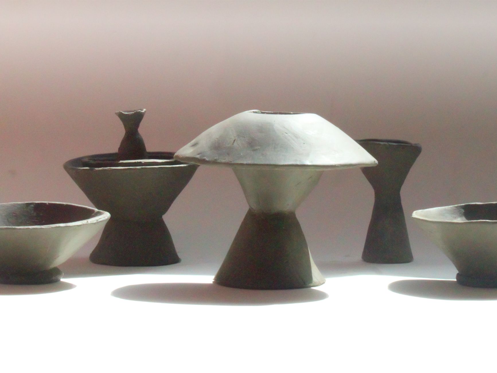 photograph of conical clay vases, jugs and vessels in different sizes or forms