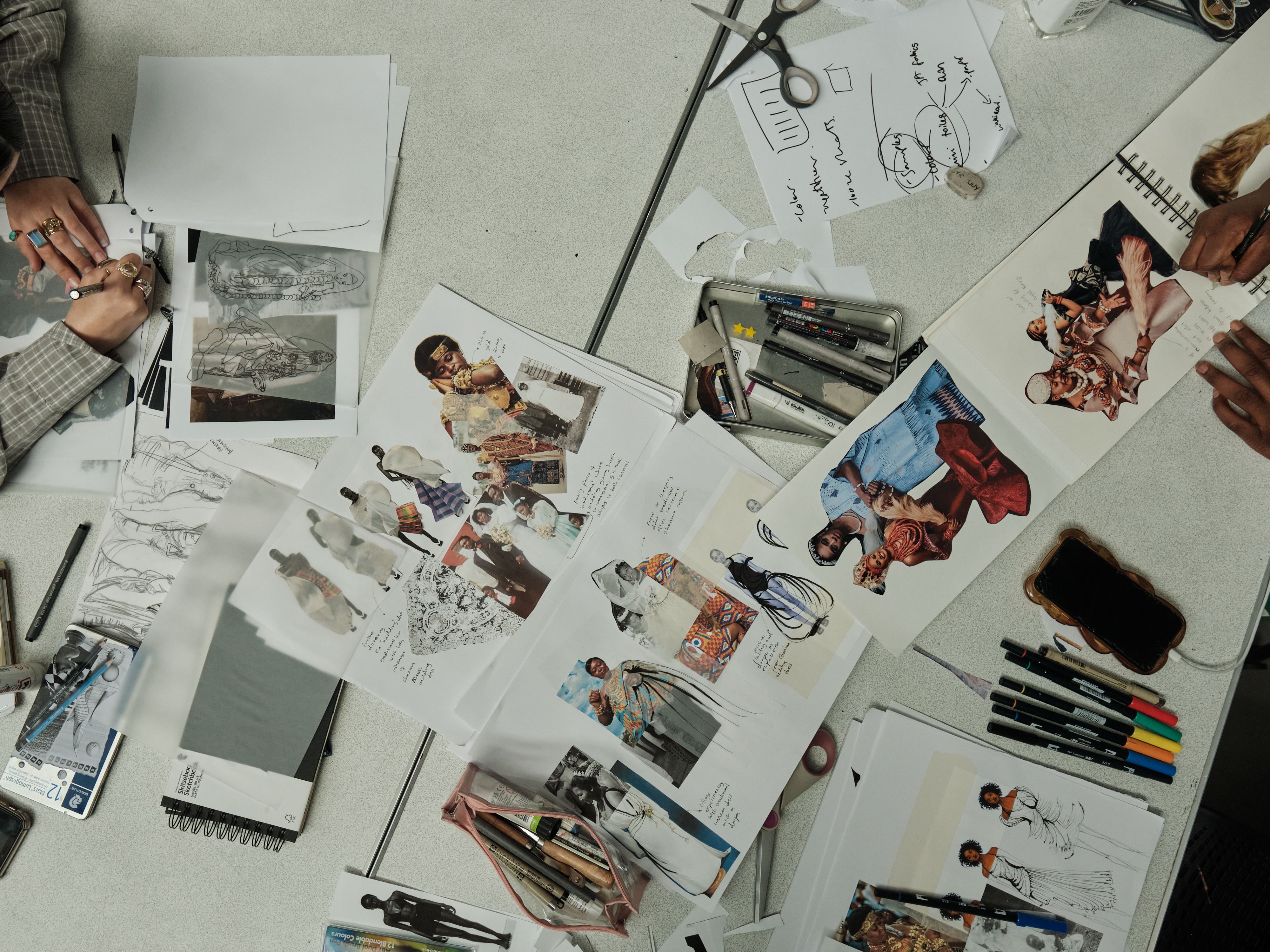 student working on collage of images