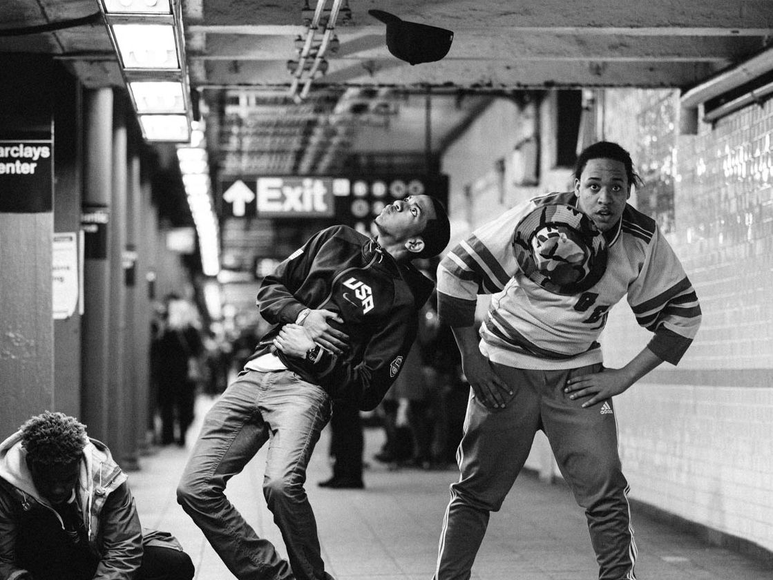 3 male street dancers doing a performance on the subway