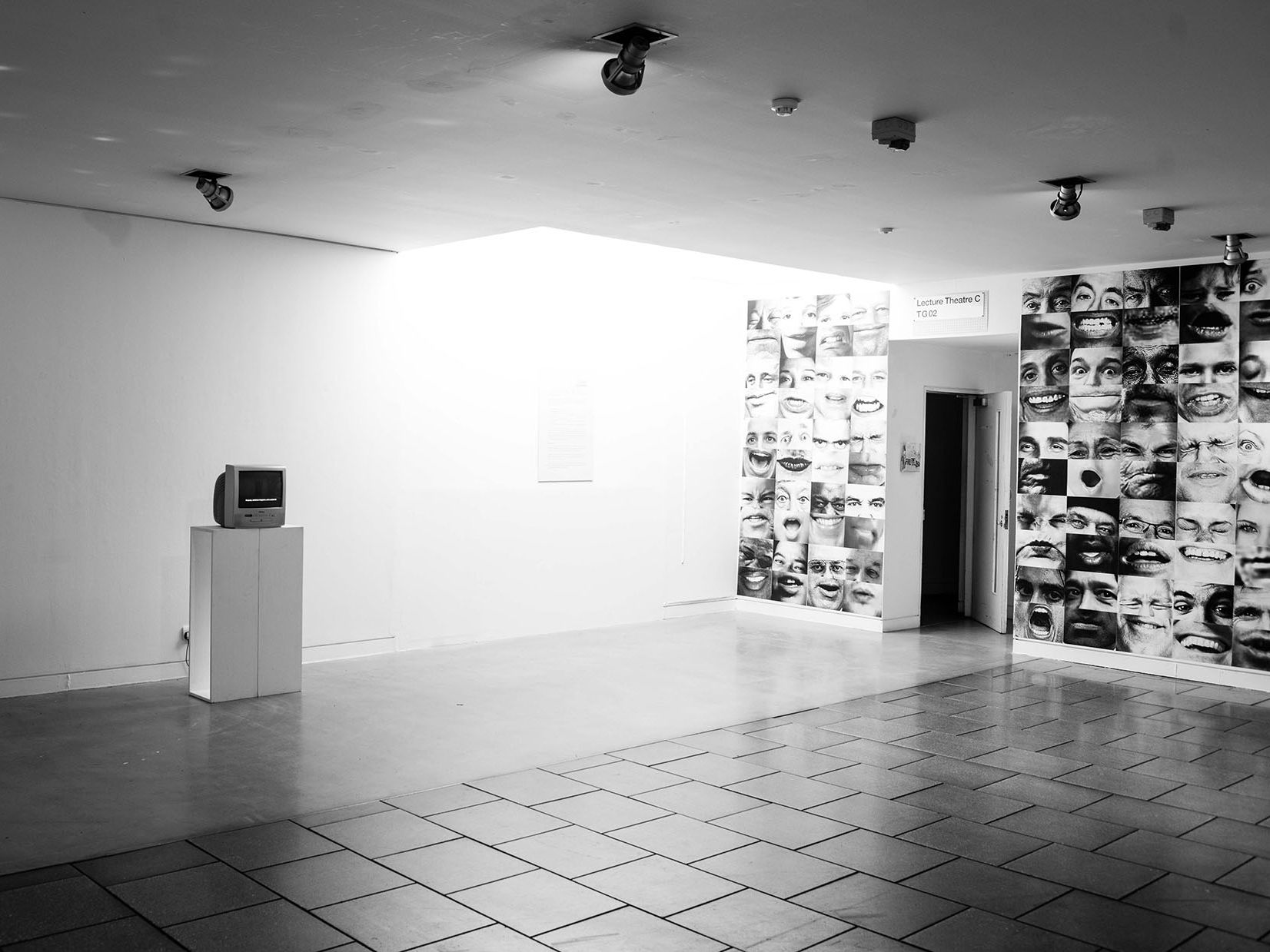 a black and white photo of an exhibition space