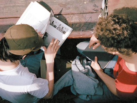 Two students reading reference books
