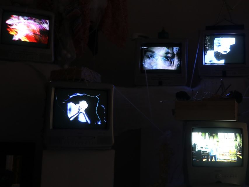 Still from a sound arts film featuring speakers and televisions.