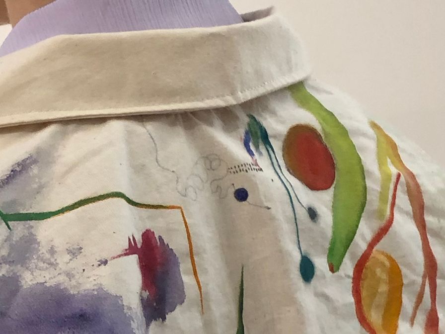 The view of a woman's back wearing a white jumpsuit which has been painted with Bauhaus-inspired designs, to be worn during the Bauhaus 100 performances in September 2019.