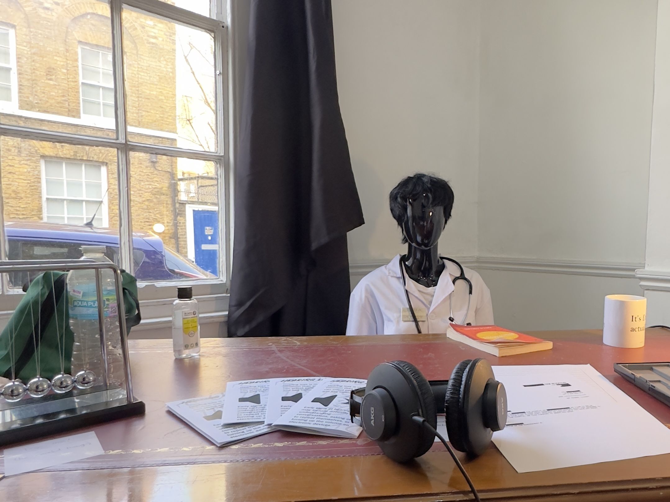 Model of a doctor sitting at a desk