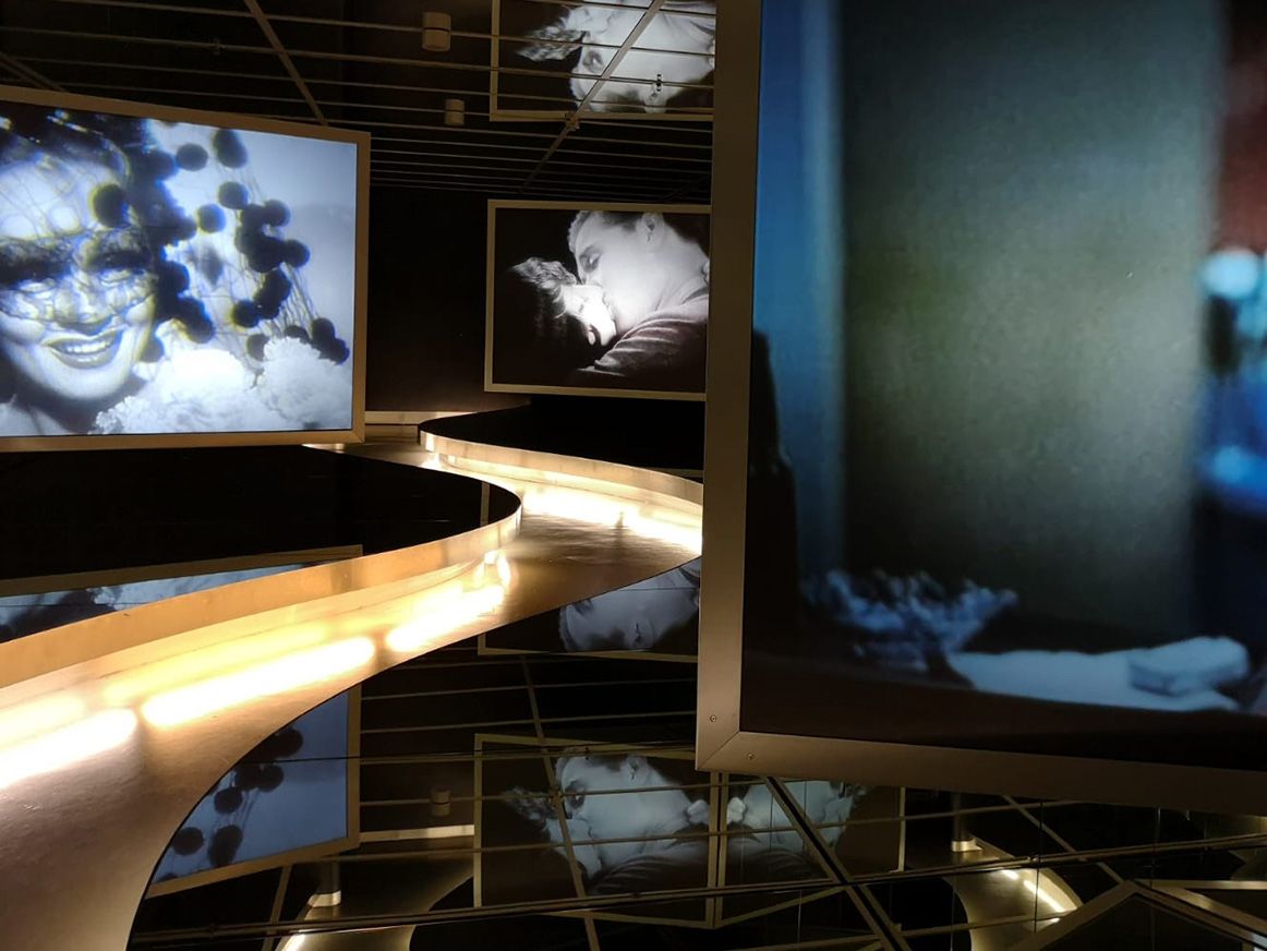 Image depicts film stills projected onto exhibition screens.