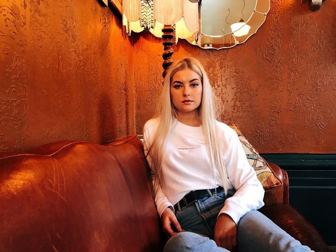 Blonde girl posing in Maison de Choup t-shirt