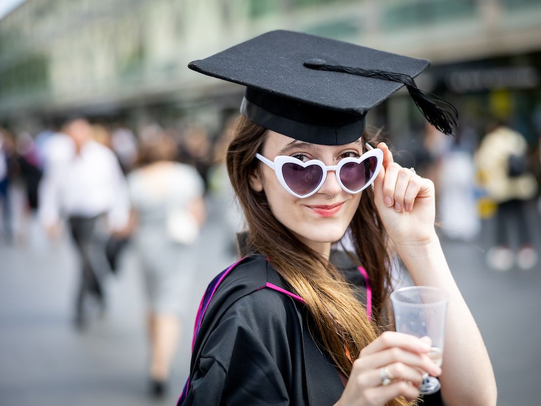 Photo of a graduate looking into the camera.