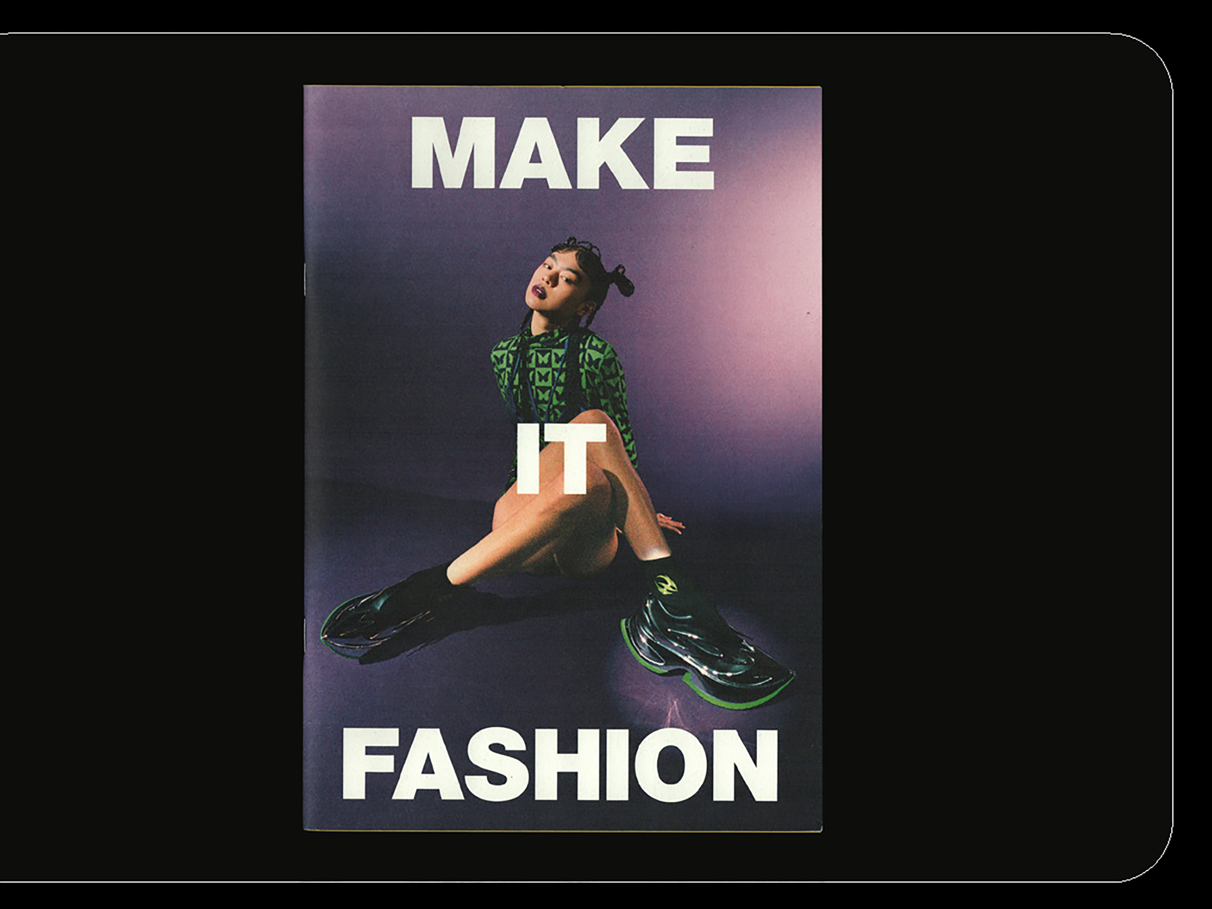 Mockup of the cover of 'Make it fashion' zine showing a fashion image of model posing in the studio and large white sans serif letters that say MAKE IT FASHION.