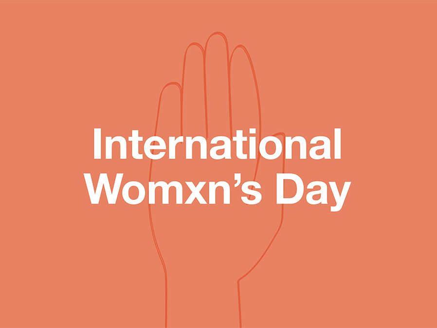 A peach-coloured banner which reads: 'International womxn's day'.