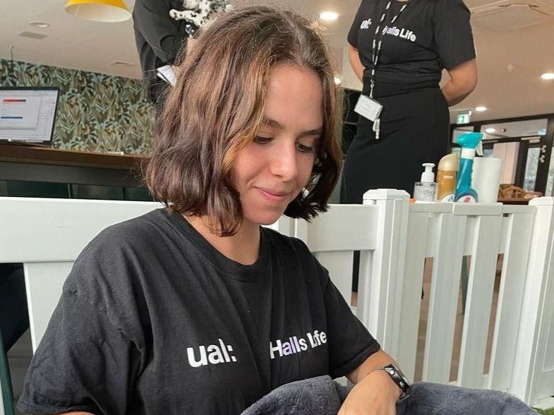 Woman holding a dalmatian puppy in her lap