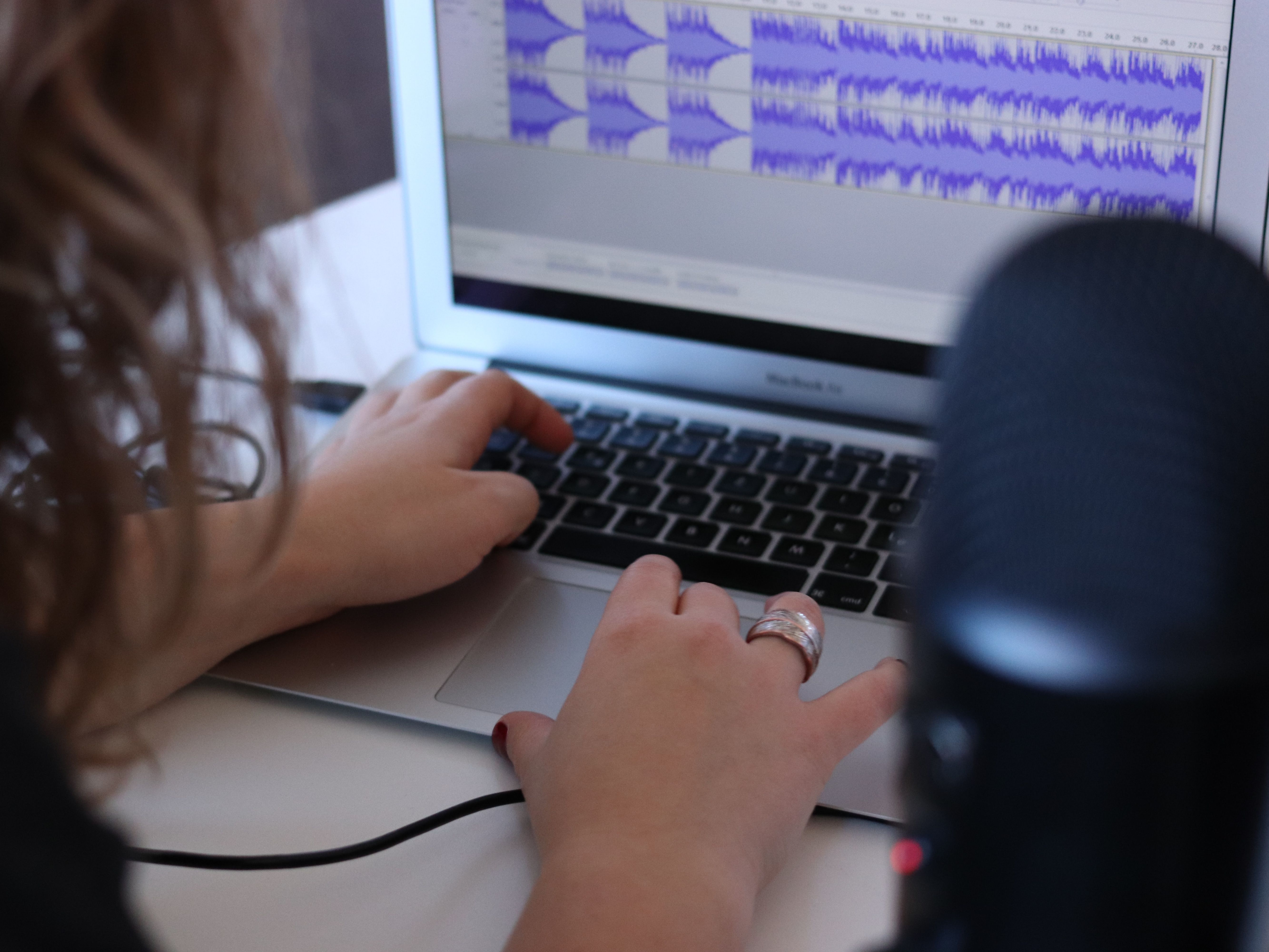 a person editing audio on a computer
