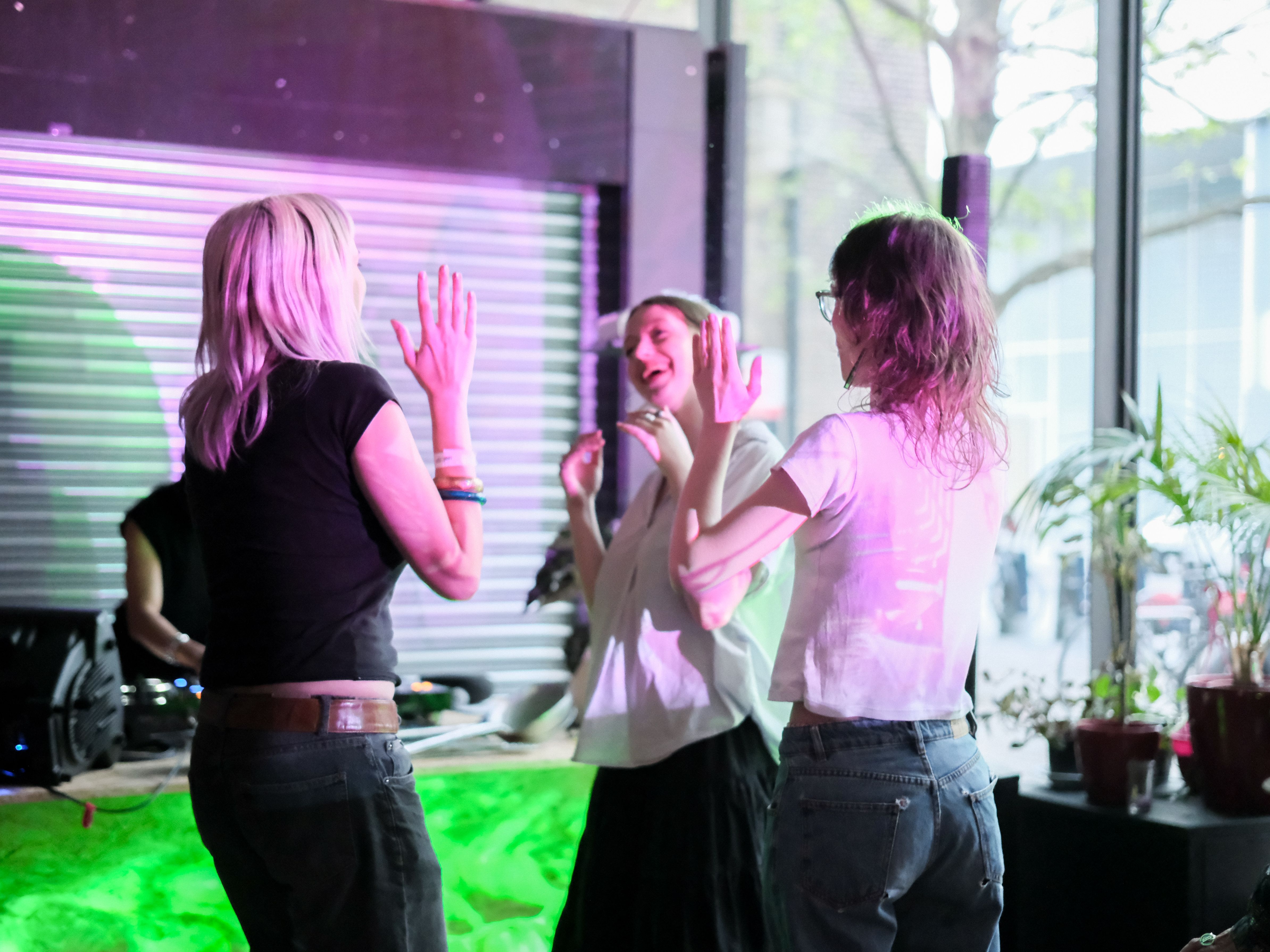 Three people dancing and laughing 