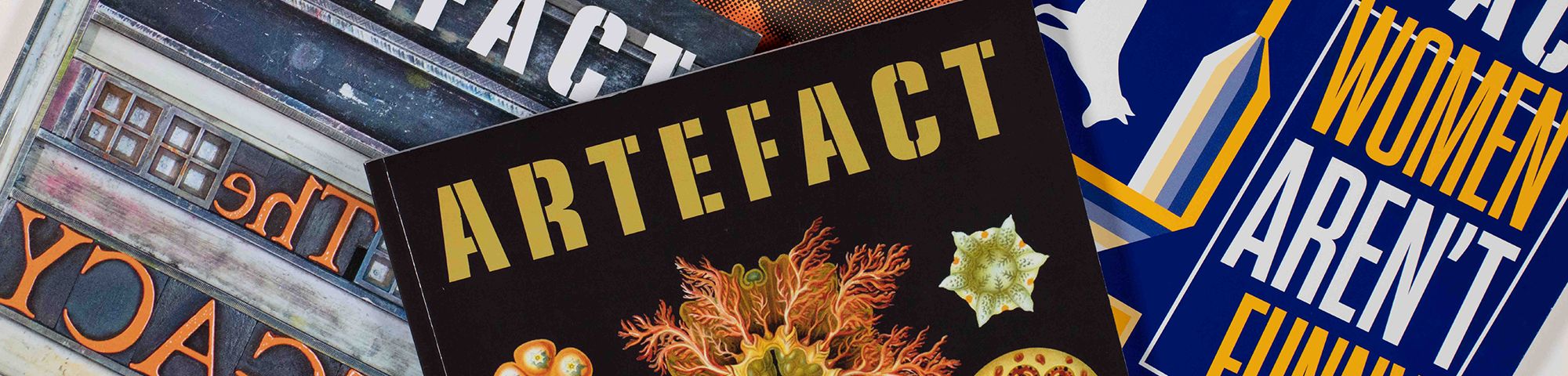 A fan of magazines covers shot against a white background.