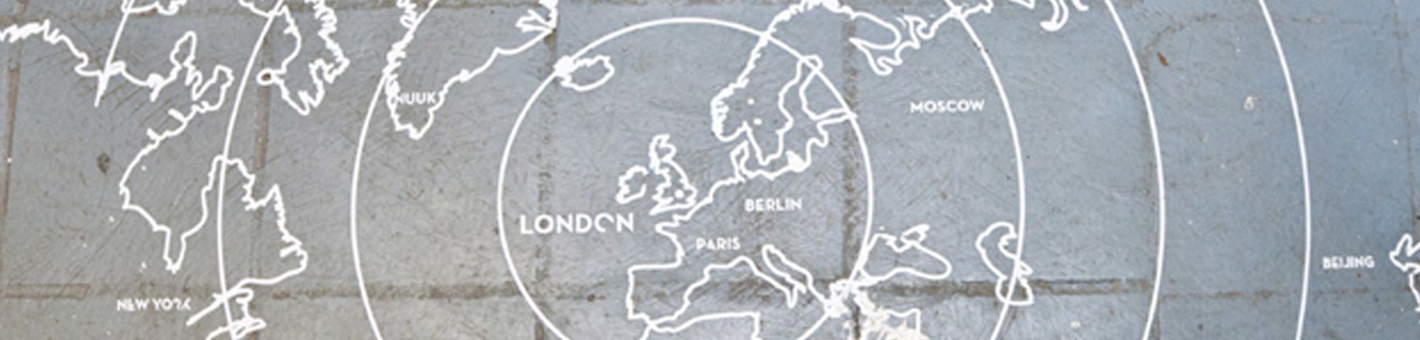 A map of Europe and other continents drawn on a cobbled floor