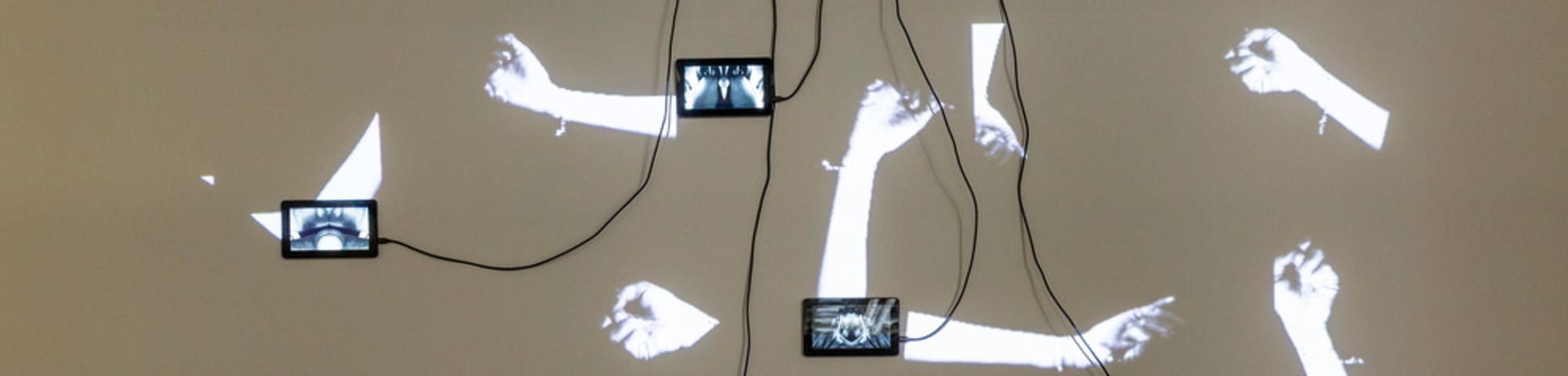 Art/light installation made out of small video screens and projections of arms. Image used for decorative purpose only.
