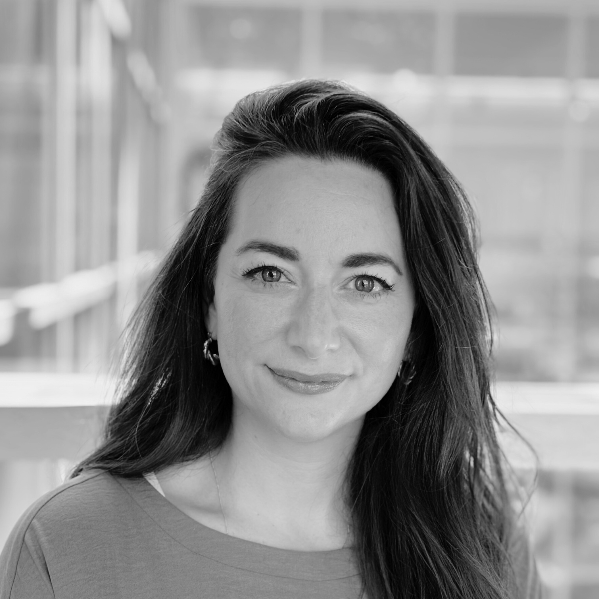 Laura Solomon, R&D Fellow in Textile Science and Technology, with dark brown hair and smiling at the camera