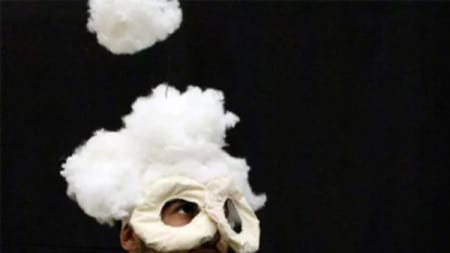 Person wearing a white eye mask with white cotton wool on head