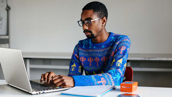 Student sitting at a desk using a laptop