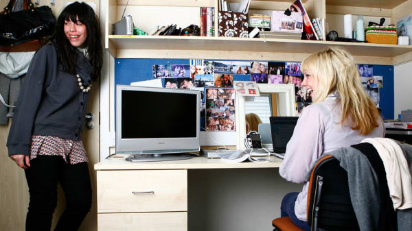 Photo of two students in a bedroom with a desk at Don Gratton House