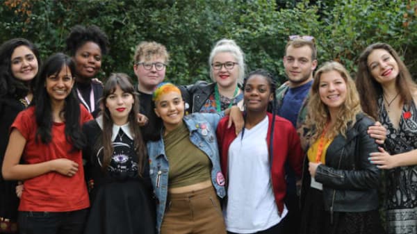 A group of people stood closely together
