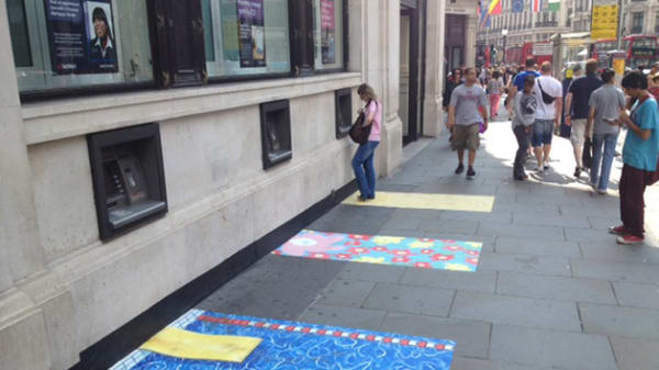 Colourful patterned paving stones around cash machines