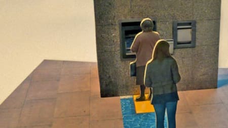 Cut out card figures of people standing in line at an ATM