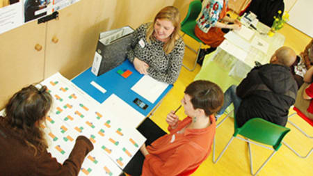 Overview of people working at a table