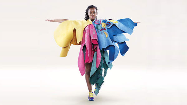 Photo of a woman wearing a colourful yellow, pink, green and blue outfit