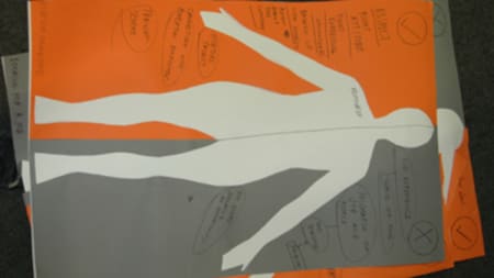 Graphic of the outline of a body against orange and grey background