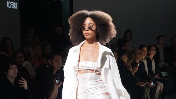Model with afro in white taped clothing on the BA18 catwalk