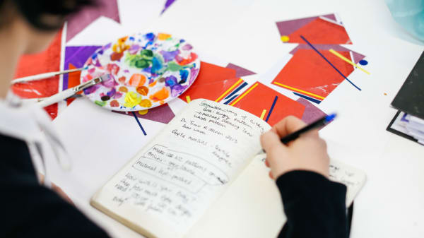 Student writing in a notebook