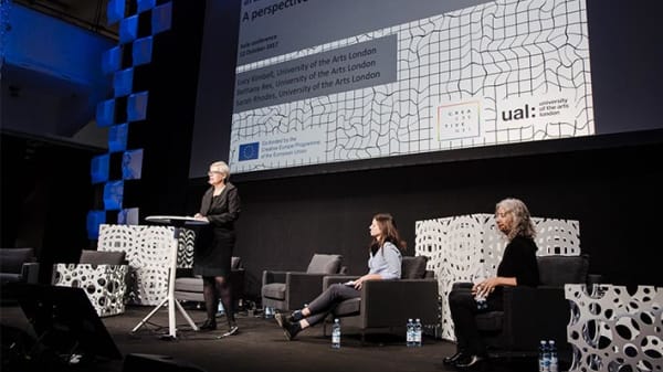 Director Lucy Kimbell talking at conference on stage
