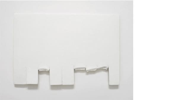 A white piece of material with bits torn off the bottom