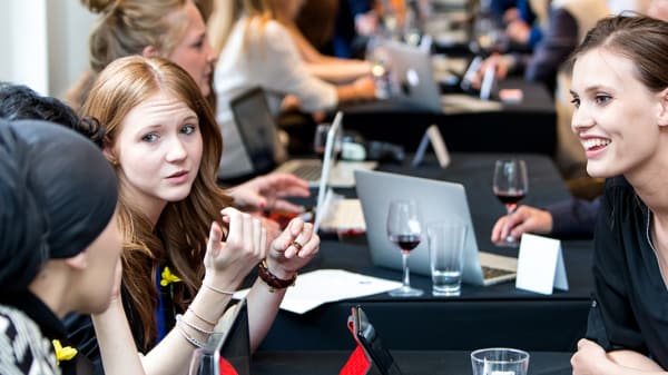 Students engaging in conversation across a long table as part of an industry event at BAFTA.