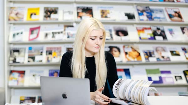Daisy Hristova reading a magazine