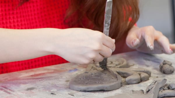 Student working on a ceramic model