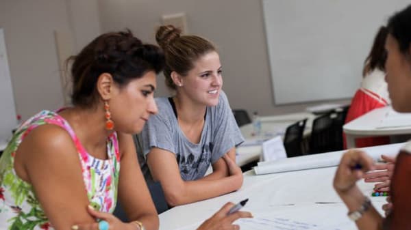 Photo of two women working at a table