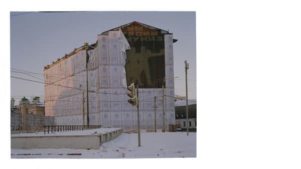 A covered building with a section showing a communist mural