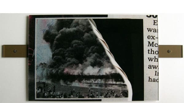 A newspaper clipping fastened to a bracket