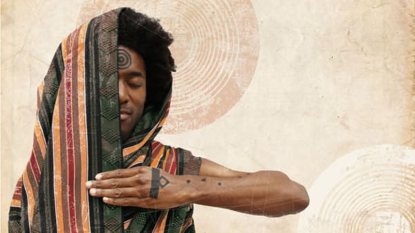 A photograph of a person looking peaceful with their eyes closed and half of their face covered by a garment