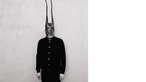 A person wearing a Sardinian bull mask