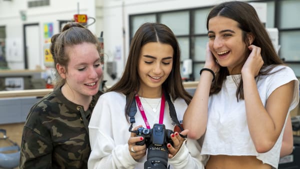 Students viewing photos on camera