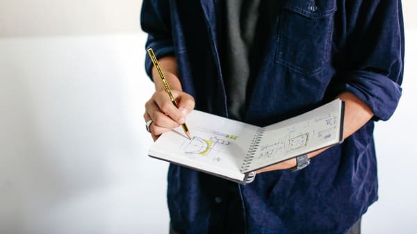Student holding a sketchbook