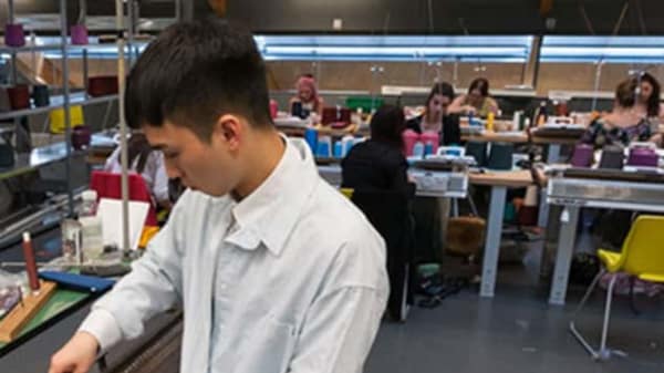 A student working in the knit workshop