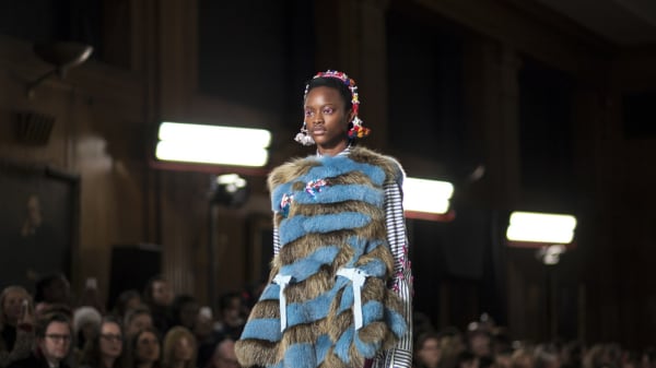 A female model wearing fur and stripes