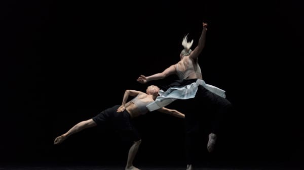 Two people dancing on a stage