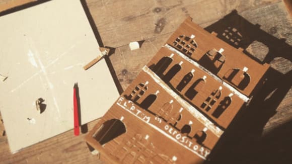 Photo of a cardboard model of a building lying on a table
